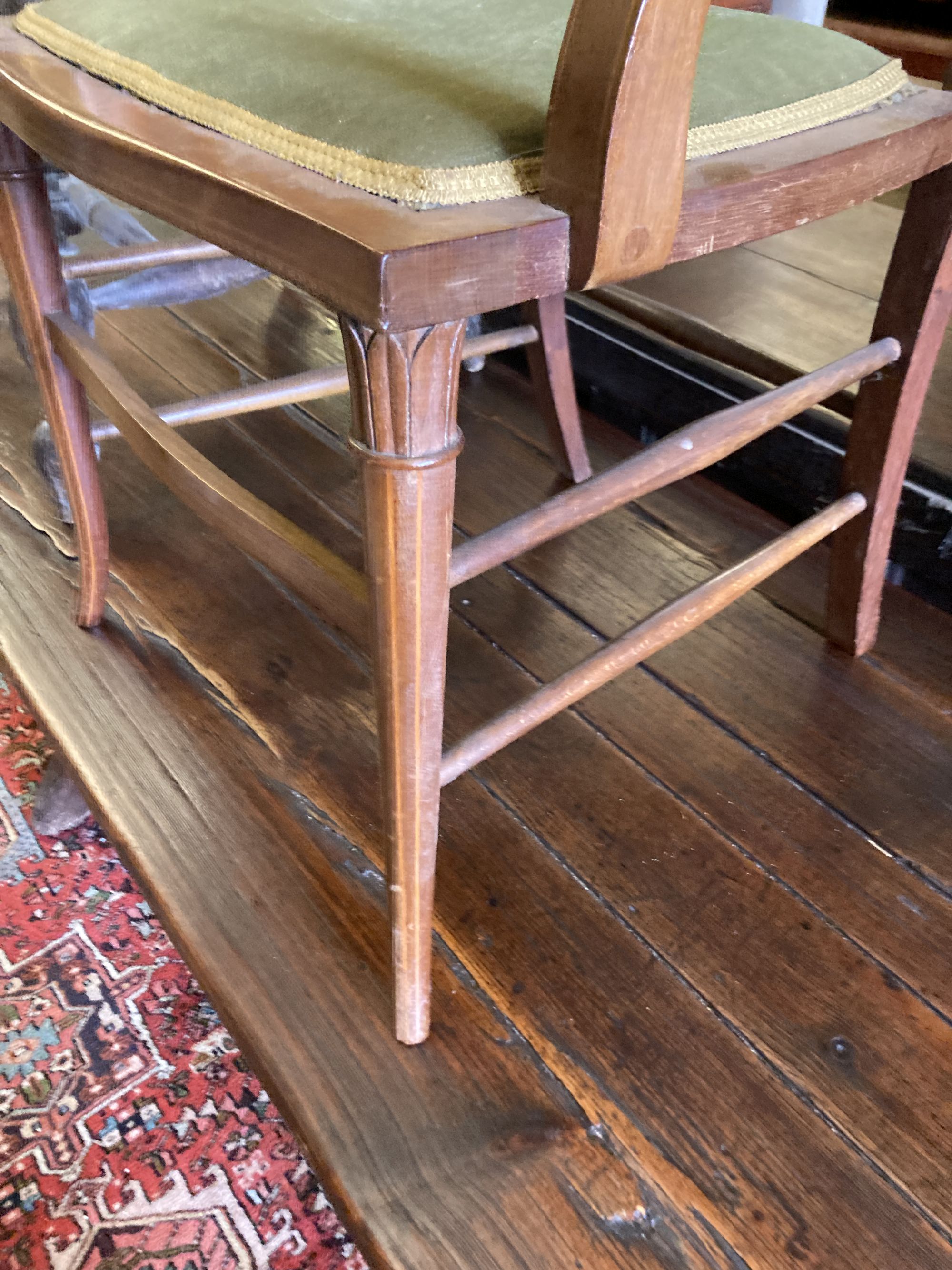 A Victorian bleached elm and ash smokers bow chair and an Edwardian inlaid mahogany elbow chair (2)